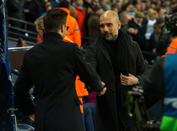 epa06587631 Manchester City&#039;s head coach Pep Guardiola (R) and Basel&#039;s head coach Raphael Wicky schake hands before the UEFA Champions League round of 16 second leg soccer match between Manc ...