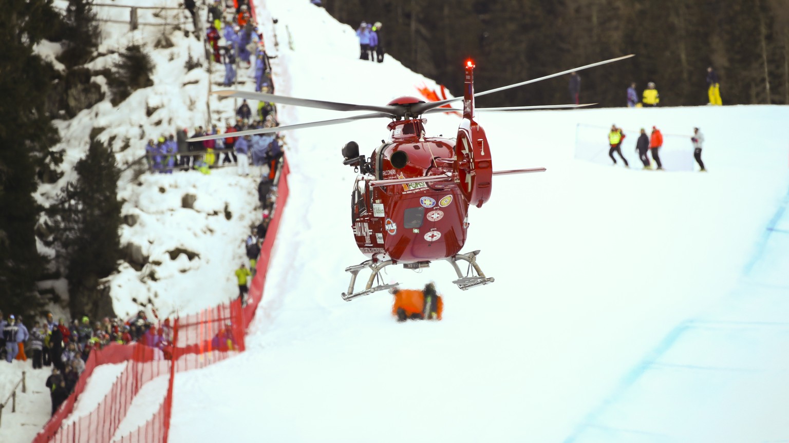 A rescue helicopter leaves with on board Switzerland&#039;s Marc Gisin after he crashed on the course during a men&#039;s World Cup downhill, in Val Gardena, Italy, Saturday, Dec. 15, 2018. (AP Photo/ ...
