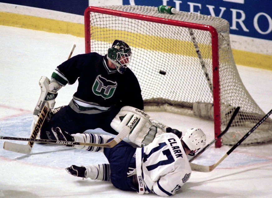 Hartford Whalers&#039; goalkeeper Sean Burke looks over his shoulder as the puck goes by into the net off the stick of Toronto Maple Leafs&#039; forward Wendal Clark (17), March 8 in Toronto. The game ...