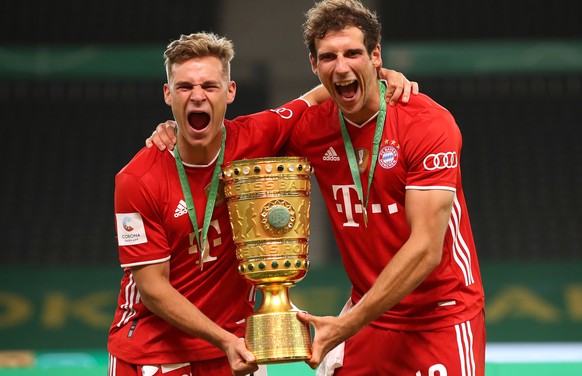 epa08528455 Joshua Kimmich (L) and Leon Goretzka of FC Bayern Munich pose with the trophy after winning the DFB Cup final match between Bayer 04 Leverkusen and FC Bayern Munich at Olympiastadion in Be ...