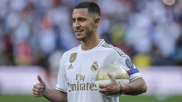 Belgium forward Eden Hazard poses for the media during his official presentation after signing for Real Madrid at the Santiago Bernabeu stadium in Madrid, Spain, Thursday, June 13, 2019. Real Madrid a ...