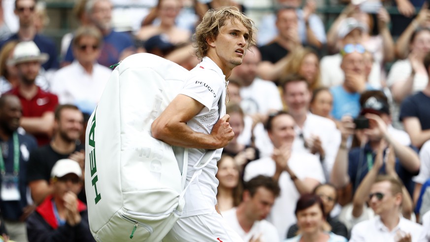 epa07687822 Alexander Zverev of Germany exits court after being defeated by Jiri Vesely of the Czech Republic in their first round match during the Wimbledon Championships at the All England Lawn Tenn ...