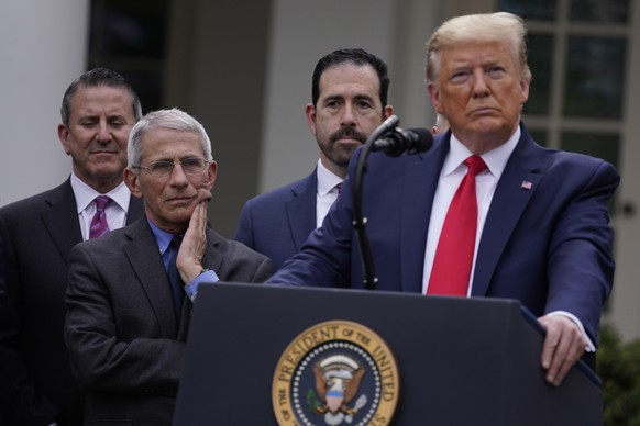 Dr. Anthony Fauci, director of the National Institute of Allergy and Infectious Diseases, second from left, and President Donald Trump, right, listen during a news conference about the coronavirus in  ...