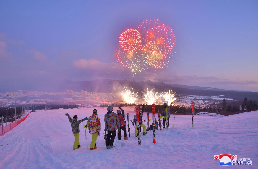 epa08040421 A photo released by the official North Korean Central News Agency (KCNA) shows people on a skiing hill overlooking fireworks during a ribbon-cutting ceremony to open a Township of Samjiyon ...