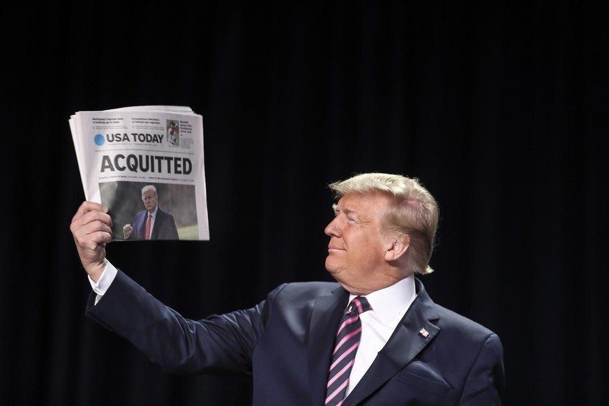 epa08197934 US President Donald J. Trump holds a copy of the USA Today newspaper fronting with his Impeachment acquittal, as he arrives to the 68th Annual National Prayer Breakfast in Washington, DC,  ...