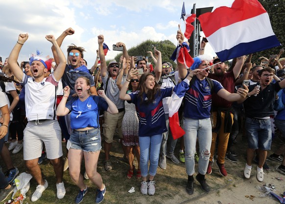 Supporters of the French soccer team celebrate after France won the World Cup final between France and Croatia, Sunday, July 15, 2018 on the Champ de Mars in Paris. France won its second World Cup tit ...