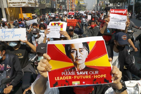 A protester holds an image of deposed Myanmar leader Aung San Suu Kyi as fellow protesters march around Mandalay, Myanmar on Monday, Feb. 8, 2021. A protest against Myanmar&#039;s one-week-old militar ...