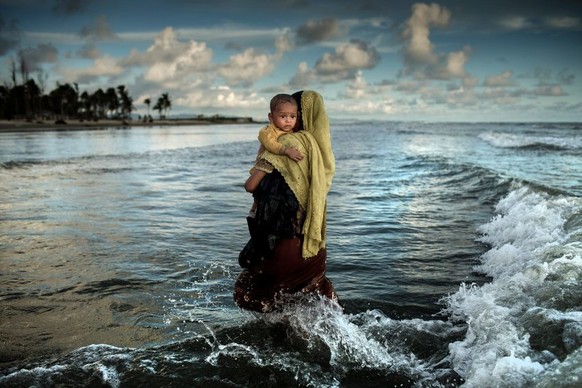 HANDOUT - Das zweitplatzierte Foto des internationalen Foto-Wettbewerbs «Unicef-Foto des Jahres 2017&quot; des Fotografen K.M. Asad zeigt ein Rohingya-Flüchtling mit ihrem Sohn nachdem sie am 14.09.20 ...