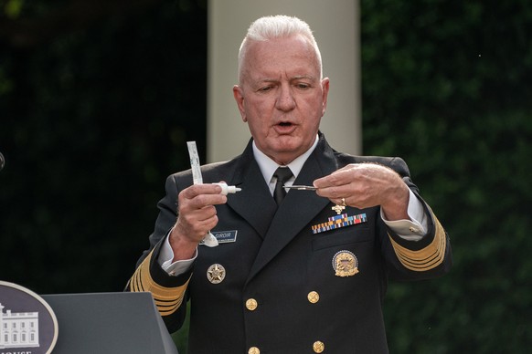 epa08704693 Assistant secretary for Health and Human Services Admiral Brett Giroir demonstrates a COVID-19 test during an update on the Nation&#039;s Coronavirus Testing Strategy, in the Rose Garden o ...