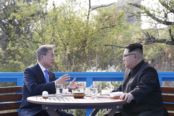 In this April 27, 2018 photo, North Korean leader Kim Jong Un, right, and South Korean President Moon Jae-in, left, talk at a footbridge at the border village of Panmunjom in the Demilitarized Zone, S ...