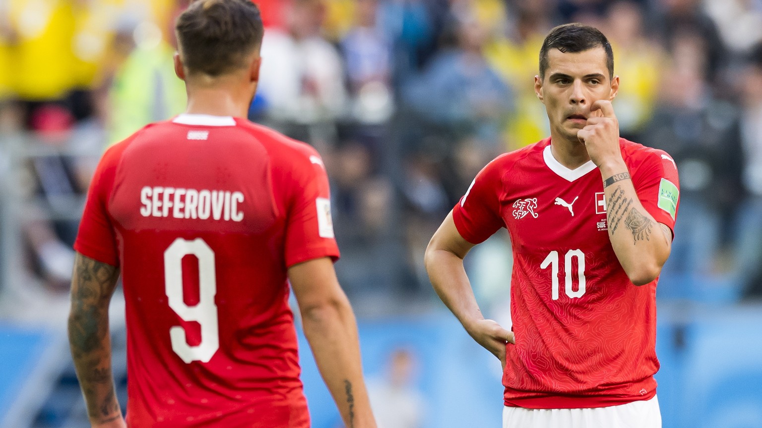 epa06861333 Switzerland&#039;s forward Haris Seferovic (L) and Switzerland&#039;s midfielder Granit Xhaka react during the FIFA World Cup 2018 round of 16 soccer match between Sweden and Switzerland i ...