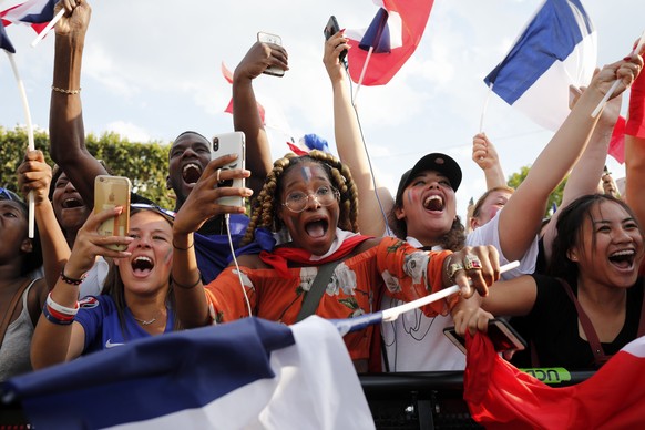 French soccer team supporters celebrate as France wins the World Cup final between France and Croatia, Sunday, July 15, 2018 in Paris. France won its second World Cup title by beating Croatia 4-2. (AP ...