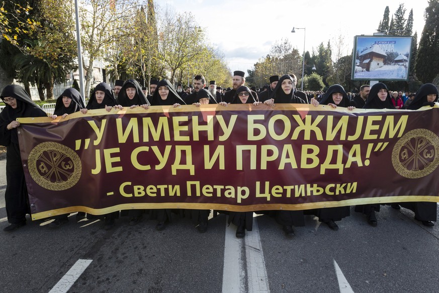 Serbian Orthodox Church clergy in Montenegro march and hold a banner reading: &#039;&#039;Judgment and Justice are in God&#039;s name&#039;&#039; as they protest the planned adoption of a religious la ...