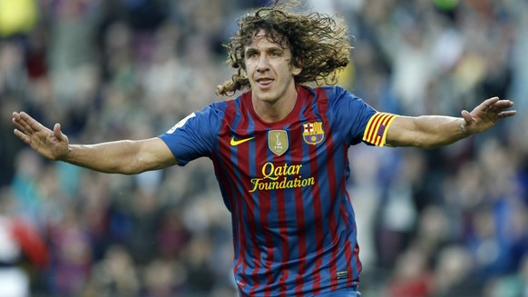 epa04109518 (FILE) A file picture dated 02 May 2012 shows FC Barcelona defender Carles Puyol celebrating a goal against Malaga during a Spanish Primera Division soccer match at the Camp Nou stadium in ...