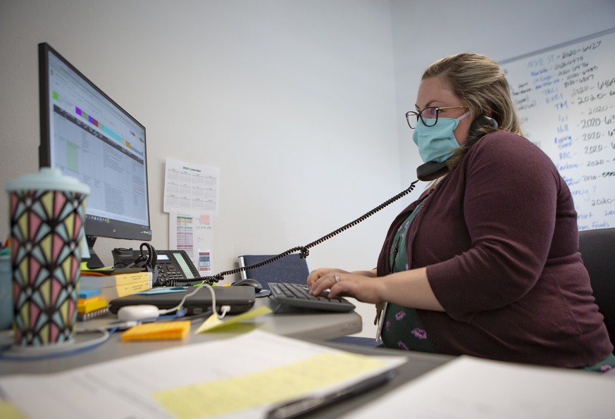 Heather Griggs, operations chief of the Umatilla County Public Health Department COVID-19 contact tracing center in Pendleton, Ore., checks in with public health staff in neighboring Morrow County abo ...