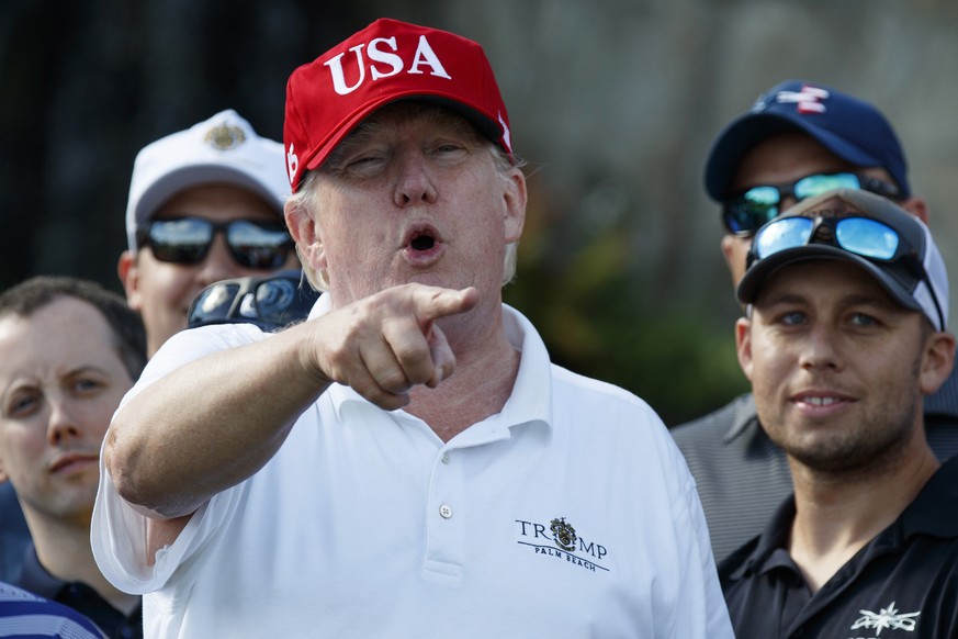 President Donald Trump speaks as he meets with members of the U.S. Coast Guard, who he invited to play golf, at Trump International Golf Club, Friday, Dec. 29, 2017, in West Palm Beach, Fla. (AP Photo ...
