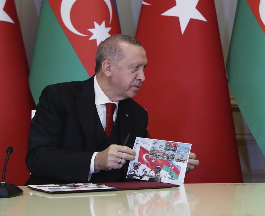 Turkey&#039;s President Recep Tayyip Erdogan, left and Azerbaijan&#039;s President Ilham Aliyev, right, talk during a joint news conference following their meeting in Baku, Azerbaijan, Thursday, Dec.  ...