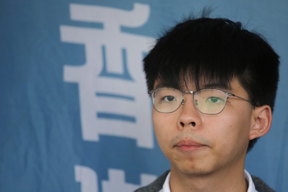 FILE - In this May 16, 2019, file photo, Pro-democracy activist Joshua Wong speaks to media at a court in Hong Kong. Members of his Demosisto party say the Hong Kong activist Wong, a leading figure in ...