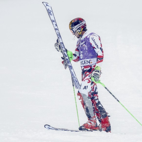 Marcel Hirscher of Austria looks at his ski after falling out of the second run of the FIS Alpine Ski World Cup slalom race at the Lauberhorn in Wengen, Switzerland, Sunday, January 17, 2016. (KEYSTON ...