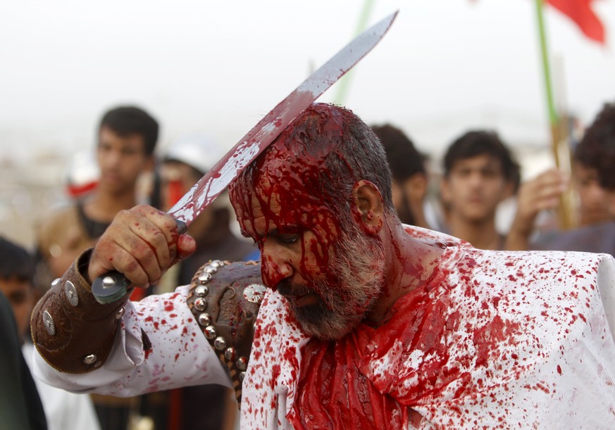 Iraq Shi&#039;ite Muslim men bleed as they gash their foreheads with swords and beat themselves to commemorate Ashura in Sadr City, Baghdad, October 24, 2015. Ashura, which falls on the 10th day of th ...