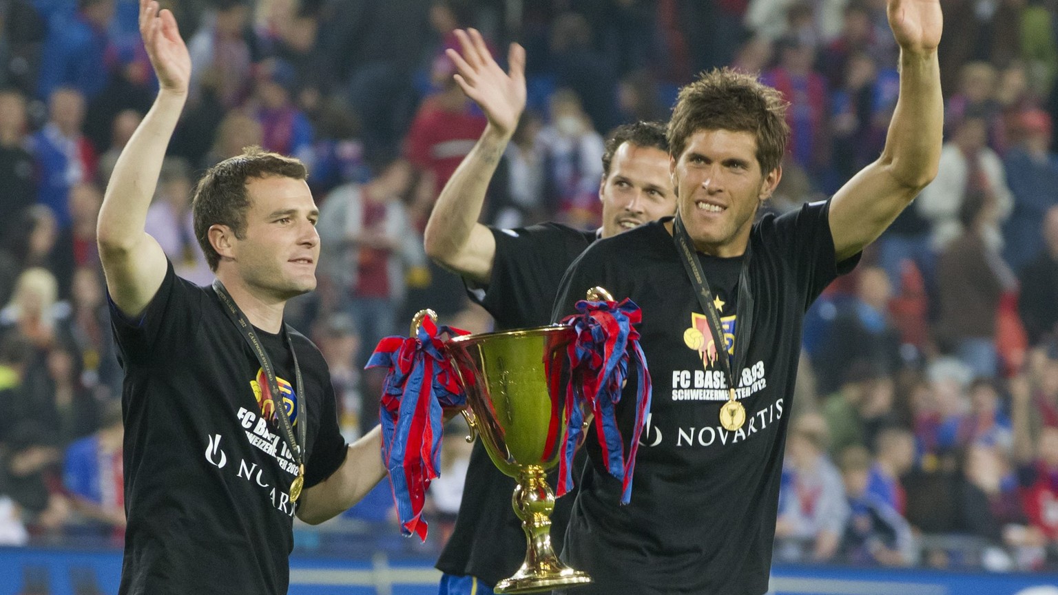 Basel&#039;s Alexander Frei, Marco Streller and Benjamin Huggel, from left, celebrate with their Trophy after the Super League soccer match between FC Basel and BSC Young Boys at the St. Jakob-Park st ...