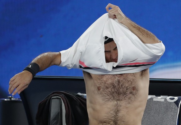 Switzerland&#039;s Roger Federer changes his shirt during a break in his second round match against Germany&#039;s Jan-Lennard Struff at the Australian Open tennis championships in Melbourne, Australi ...