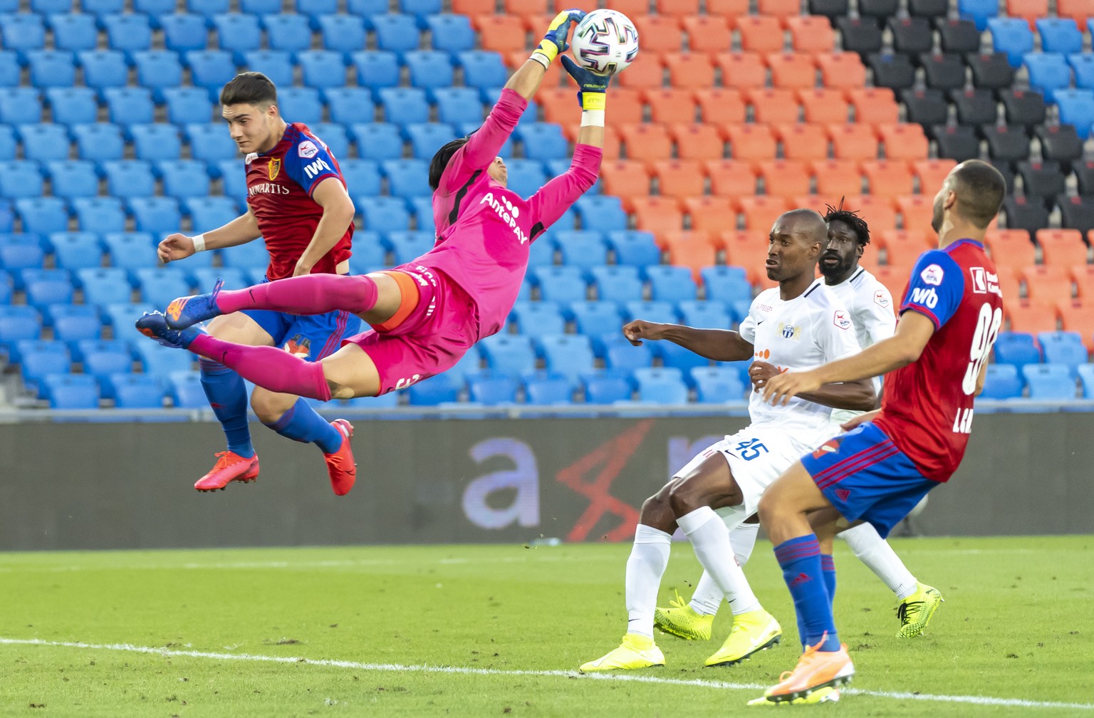 Zuerich&#039;s goalkeeper Novem Baumann, center, in action during the Super League match between FC Basel 1893 and FC Zuerich at the St. Jakob-Park stadium in Basel, Switzerland, on Tuesday, July 14,  ...