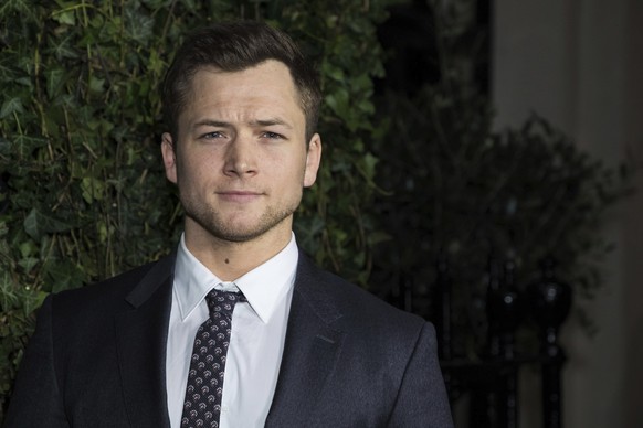 Taron Egerton poses for photographers upon arrival at the Charles Finch and Chanel pre Bafta party in London, Saturday, Feb. 17, 2018. (Photo by Vianney Le Caer/Invision/AP)