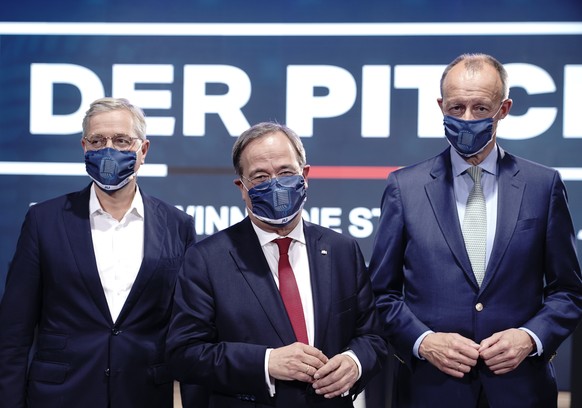 The three candidates for the chairmanship of the Christian Democratic Union party, CDU, Norbert Roettgen, left, Armin Laschet, center, and Friedrich Merz, right, attends an event of the party&#039;s y ...