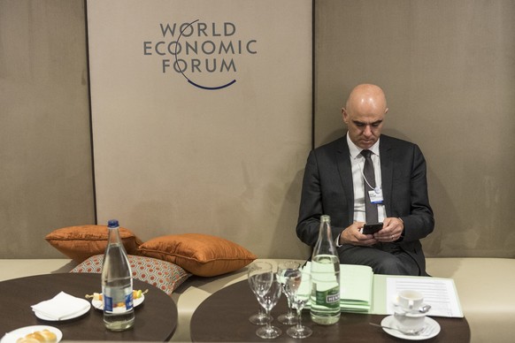 Federal councillor Alain Berset checks his Smartphone, during the 50th annual meeting of the World Economic Forum, WEF, in Davos, Switzerland, Wednesday, January 22, 2020. The meeting brings together  ...