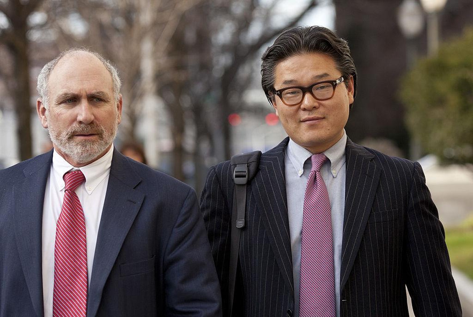 Bill Hwang, founder of of Tiger Asia Management LLC, right, exits federal court with his attorney Lawrence Lustberg in Newark, New Jersey, U.S., on Wednesday, Dec. 12, 2012. Tiger Asia Management LLC, ...