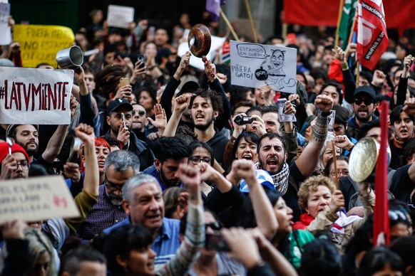 epa07939429 Chilean citizens residing in Argentina participate in a rally heading to their Consulate to protest against the situation in their country, in Buenos Aires, Argentina, 21 October 2019. EPA ...