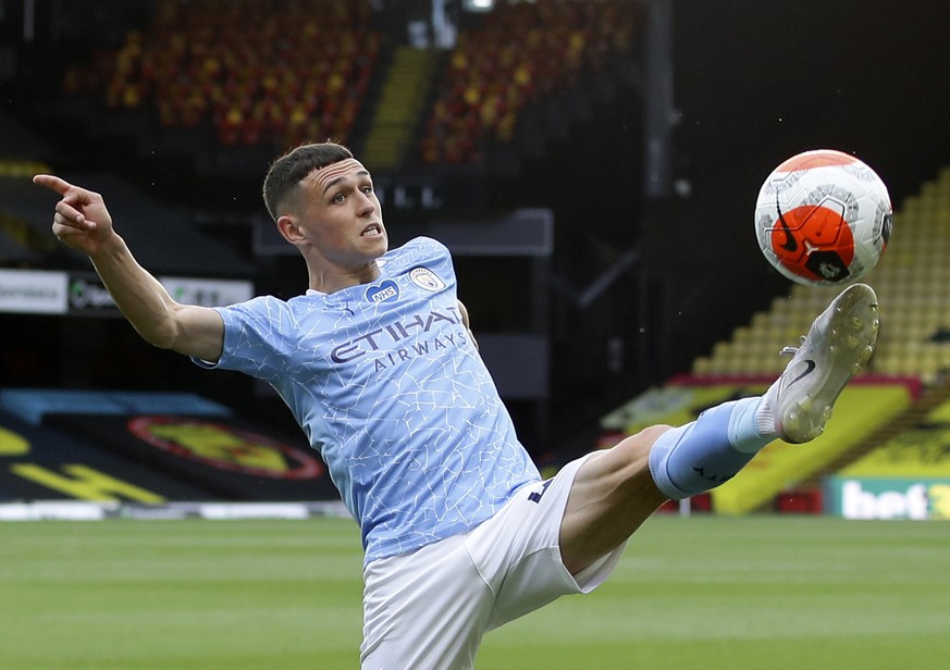 FILE - In this Tuesday, July 21, 2020 file photo, Manchester City&#039;s Phil Foden kicks the ball during the English Premier League soccer match between Watford and Manchester City at the Vicarage Ro ...