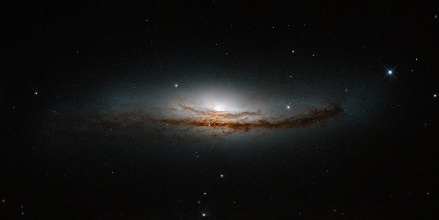 epa04135035 A handout picture released 21 March 2014 of a new Hubble image centred on NGC 5793, a spiral galaxy over 150 million light-years away in the constellation of Libra. NGC 5793 is a Seyfert g ...