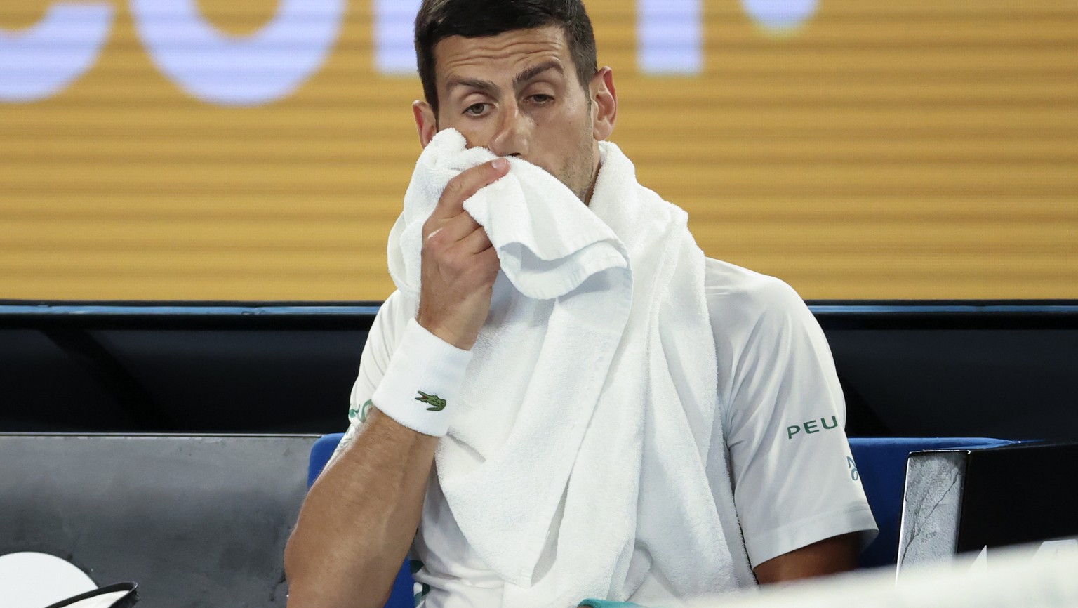 Serbia&#039;s Novak Djokovic wipes his face during a break in his fourth round match against Canada&#039;s Milos Raonic at the Australian Open tennis championship in Melbourne, Australia, Sunday, Feb. ...
