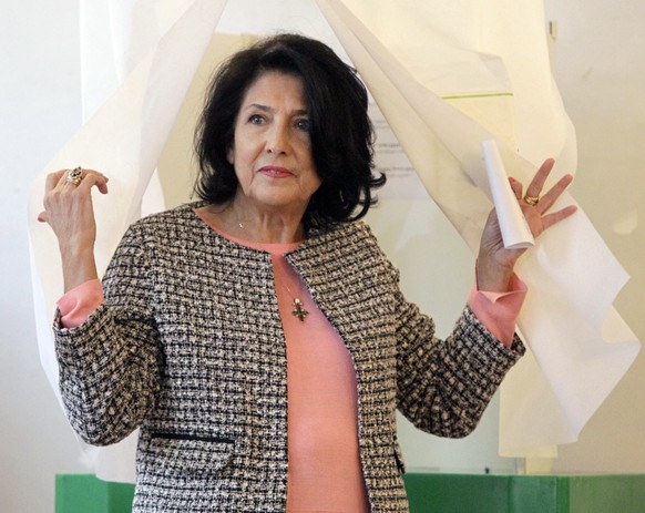 Salome Zurabishvili, former Georgian Foreign minister and presidential candidate, exits a polling booth as she prepares to cast her ballot during the presidential election at the polling station in Tb ...