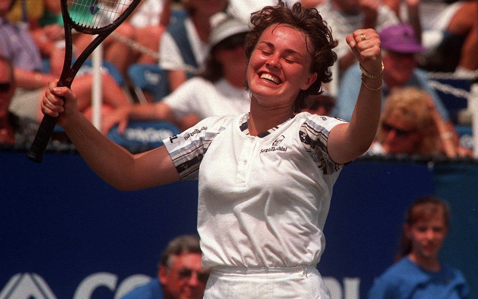 A jubilant Martina Hingis celebrates her win over Monica Seles at the Family Circle Cup on Hilton Head Island, S.C. Sunday April 6, 1997. After losing the first set, Hingis came back to win the second ...