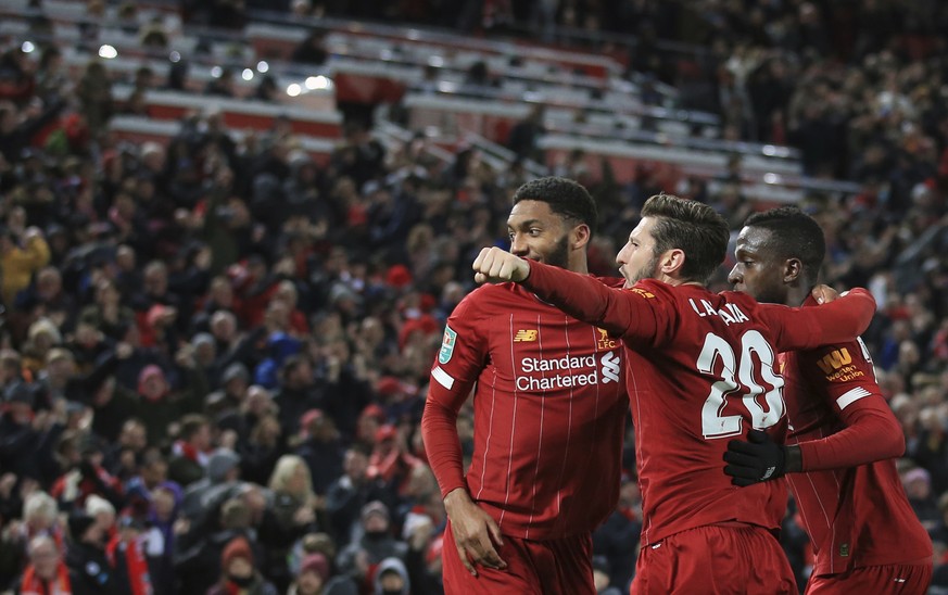 Liverpool&#039;s Divock Origi, right, celebrates with teammates after scoring his side&#039;s fifth goal during the English League Cup soccer match between Liverpool and Arsenal at Anfield stadium in  ...