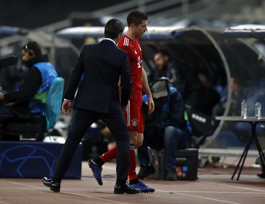 Bayern forward Robert Lewandowski, center, is escorted by Bayern coach Niko Kovac after he was replaced by Bayern forward Sandro Wagner during a Group E Champions League soccer match between AEK Athen ...