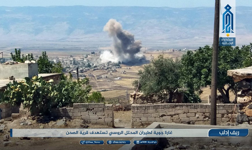 This photo released Tuesday, Sept 4, 2018 by the al-Qaida-affiliated Ibaa News Agency, shows smoke rising over buildings that were hit by airstrikes, in al-Sahan village, in the northern province of I ...