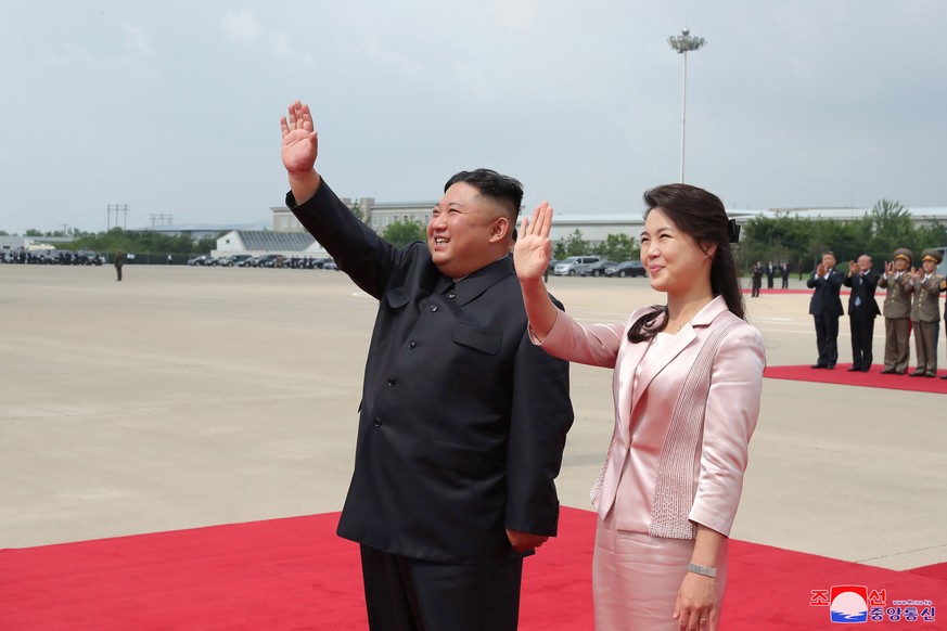 epa07664861 A photo released by the official North Korean Central News Agency (KCNA) shows North Korean Supreme Leader Kim Jong-Un (L) together with his wife Ri Sol-Ju (R) sees off President Xi Jinpin ...