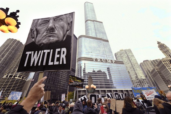 Protesters gather across the Chicago River from the Trump International Hotel and Tower while President Trump attends a fundraiser Monday, Oct. 28, 2019, in Chicago. (AP Photo/Paul Beaty)