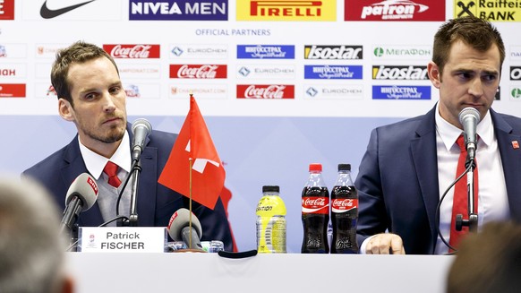 Patrick Fischer, left, head coach of Switzerland national ice hockey team, and Raeto Raffainer, right, Director of National Teams of the Swiss Ice Hockey, speak to the media during a press conference  ...