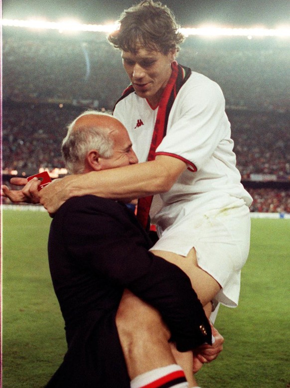 AC Milan former coach Arrigo Sacchi is embraced by Dutch forward Marco Van Basten after beating Steaua Bucarest in the Cup of Champions final in Barcelona, Spain, on May 1989. AC Milan is celebrating  ...