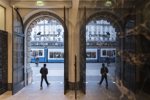 FILE- In this Feb. 14, 2018, file photo, people walk in the front of the Credit Suisse bank at the tram stop Paradeplatz in the square&#039;s centre in Zurich, Switzerland. Switzerland&#039;s financia ...