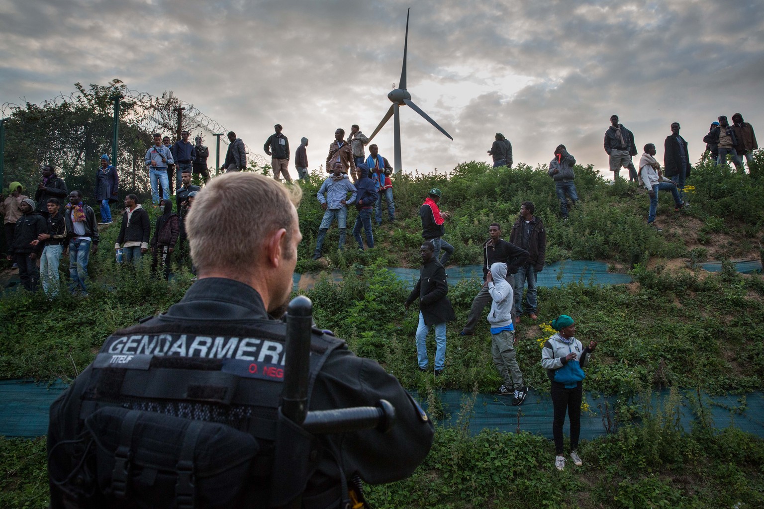 CALAIS, FRANCE - JULY 30: Gendarmerie attempt to prevent people from entering the Eurotunnel terminal in Coquelles on July 30, 2015 in Calais, France. Hundreds of migrants are continuing to attempt to ...