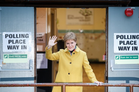 epa08064547 SNP leader Nicola Sturgeon waves after casting her vote during the general elections at Broomhouse Community Hall polling station, Glasgow, Britain, 12 December 2019. Britons go to the pol ...