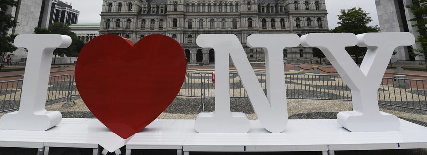 FILE - In this Tuesday, June 18, 2019, file photo, a new promotional &quot;I Love NY&quot; sign sits in the Empire State Plaza for installation in front of the New York state Capitol in Albany, N.Y. M ...