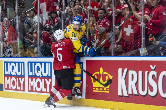 Switzerland&#039;s Yannick Weber, left, against Sweden`s Dennis Rasmussen during the game between Sweden and Switzerland, at the IIHF 2019 World Ice Hockey Championships, at the Ondrej Nepela Arena in ...