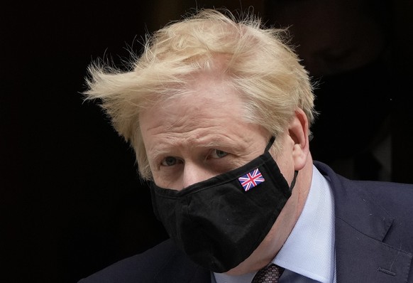 FILE - In this May 26, 2021, file photo, Britain&#039;s Prime Minister Boris Johnson leaves 10 Downing Street to attend the weekly Prime Ministers&#039; Questions session in parliament in London. Help ...